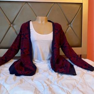 A red and blue patterned cardigan.